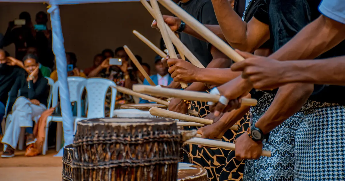 Local performers playing traditional drums during a cultural experience.